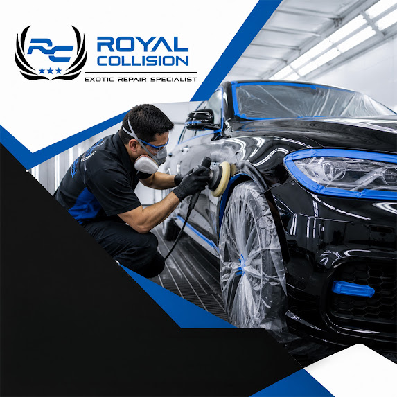 A technician wearing a respirator mask and protective gloves using a rotary buffer to polish the front fender of a taped-off black luxury vehicle inside a paint booth.