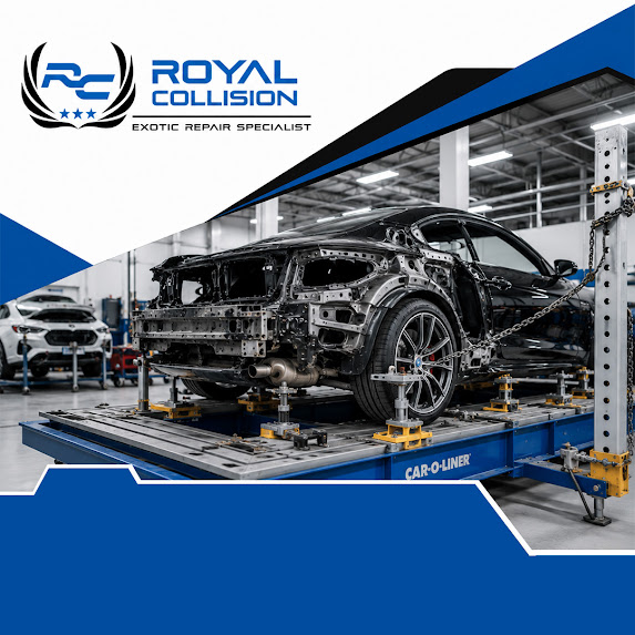 A stripped-down black luxury car secured onto a Car-O-Liner frame straightening bench system inside an auto body repair facility.