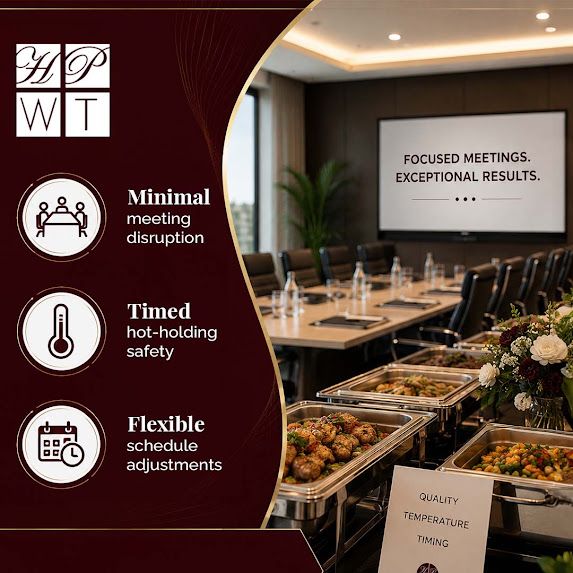 Stainless steel chafing dishes filled with hot catering items set up along a buffet line in a corporate conference room.