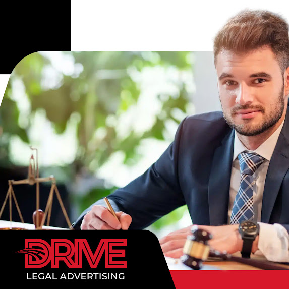 Professional male attorney in a suit sitting at his office desk with a gavel and scales of justice in the background, representing Drive Legal Advertising LLC.