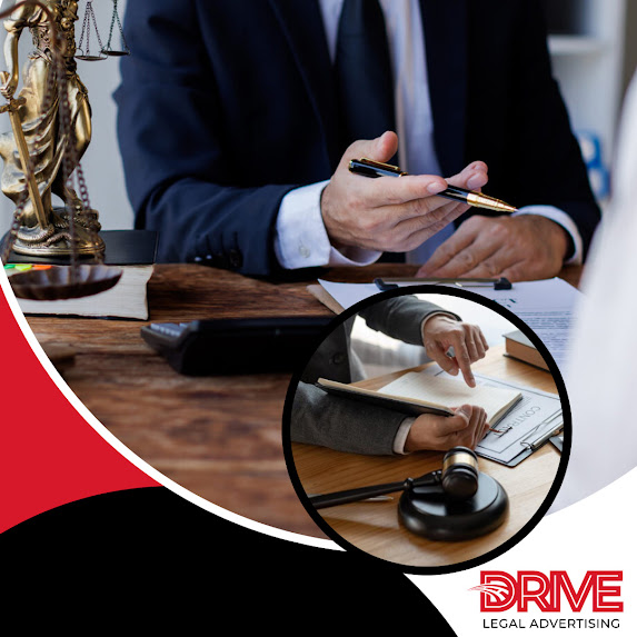 A male lawyer in a suit holding a pen while explaining legal document details to a client at a desk near a Lady Justice statue, branded for Drive Legal Advertising LLC.